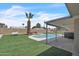 Landscaped backyard featuring a private pool, hot tub, artificial turf, and patio at 530 E Draper St, Mesa, AZ 85203