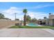 View of a backyard with a private pool, swing, brick fire pit, and artificial turf at 530 E Draper St, Mesa, AZ 85203
