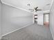 Spacious bedroom with gray walls, carpet flooring, ceiling fan, and attached bathroom at 530 E Draper St, Mesa, AZ 85203
