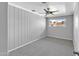 Bedroom features wood panel accent wall, carpet flooring, neutral color palette and ceiling fan at 530 E Draper St, Mesa, AZ 85203