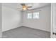 Neutral bedroom with a ceiling fan, large window, and new carpeting at 530 E Draper St, Mesa, AZ 85203