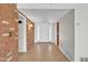 Bright entryway with tile flooring, brick accent wall, and a white front door at 530 E Draper St, Mesa, AZ 85203