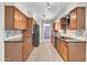 Updated kitchen features warm wood cabinets, granite countertops, and stainless steel appliances at 530 E Draper St, Mesa, AZ 85203