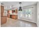Sunlit eat-in kitchen with warm wood cabinets, modern appliances, and a view to the backyard at 530 E Draper St, Mesa, AZ 85203