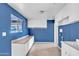 Bright laundry room with white cabinets, a utility sink, and a large window at 530 E Draper St, Mesa, AZ 85203