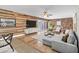 Bright living room with hardwood floors, wood accent wall, and sliding glass doors for indoor-outdoor living at 530 E Draper St, Mesa, AZ 85203