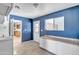 Blue mud room with tile floors, white door, window, and built in cabinets at 530 E Draper St, Mesa, AZ 85203