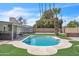 Backyard with a private pool, manicured artificial turf, and covered patio at 530 E Draper St, Mesa, AZ 85203