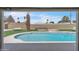 Backyard view featuring a private pool with artificial turf and a brick fire pit at 530 E Draper St, Mesa, AZ 85203