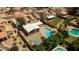 Aerial view showcases a private backyard oasis with a pool, putting green, covered patio, and meticulously landscaped grounds at 5407 W North Ln, Glendale, AZ 85302