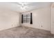 Bedroom with neutral carpet, window, and ceiling fan at 5407 W North Ln, Glendale, AZ 85302