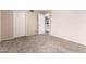 Bedroom featuring neutral carpet, white door, and a closet at 5407 W North Ln, Glendale, AZ 85302