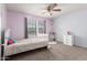 A bedroom featuring pink and gray walls, a crib, a ceiling fan, and carpeted floor at 5407 W North Ln, Glendale, AZ 85302