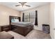 Comfortable bedroom with neutral walls, ceiling fan, and large window for natural light at 5407 W North Ln, Glendale, AZ 85302