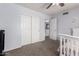 Bedroom featuring a ceiling fan, carpeted floor, and closet doors at 5407 W North Ln, Glendale, AZ 85302