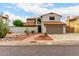 Charming two-story home featuring a desert landscape, two-car garage, and red tile roofing at 5407 W North Ln, Glendale, AZ 85302