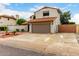 View of the home's exterior with driveway leading to a two-car garage at 5407 W North Ln, Glendale, AZ 85302