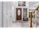 Inviting foyer featuring tiled floors, staircase, and a decorative front door at 5407 W North Ln, Glendale, AZ 85302