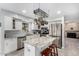 Well-equipped kitchen with stainless steel appliances, center island, granite counters and pot rack, perfect for cooking at 5407 W North Ln, Glendale, AZ 85302