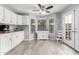 Bright kitchen features white cabinets, updated appliances, and a cozy dining area with ample natural light at 5407 W North Ln, Glendale, AZ 85302