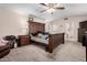 This is a primary bedroom with a large bed and a ceiling fan at 5407 W North Ln, Glendale, AZ 85302