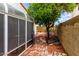 Side yard features a brick path, fruit tree, and rock landscaping that adds charm and character to the property at 5407 W North Ln, Glendale, AZ 85302