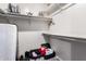 Walk-in closet featuring storage, white shelving, and suitcase at 5407 W North Ln, Glendale, AZ 85302