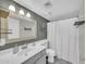 Bathroom featuring decorative mirror, tiled floors, and shower with curtain at 633 W Southern Ave # 1131, Tempe, AZ 85282