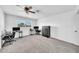 Bedroom featuring neutral colored carpet, ceiling fan, and large window at 633 W Southern Ave # 1131, Tempe, AZ 85282