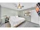 Cozy bedroom features neutral paint, ceiling fan, window, and mounted TV at 633 W Southern Ave # 1131, Tempe, AZ 85282