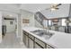 Clean kitchen sink and countertop overlooking living room fireplace, creating an open and inviting space at 633 W Southern Ave # 1131, Tempe, AZ 85282