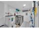 Functional laundry room with washer, dryer, shelving, and water heater, providing convenience and organization at 633 W Southern Ave # 1131, Tempe, AZ 85282