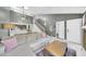 Bright open concept living room with high ceilings, open to the kitchen, and staircase with gallery wall at 633 W Southern Ave # 1131, Tempe, AZ 85282