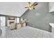 Bright living room with vaulted ceilings, white tile floors, and fireplace with TV at 633 W Southern Ave # 1131, Tempe, AZ 85282