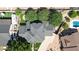 Home with a well-maintained dark gray roof, artificial turf lawn and mature trees at 645 S 54Th St, Mesa, AZ 85206