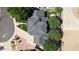 House featuring a gray roof and pristine artificial turf lawn surrounded by mature trees at 645 S 54Th St, Mesa, AZ 85206