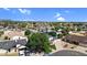 Suburban neighborhood featuring a lush green landscape, neatly arranged homes, and clear blue skies at 645 S 54Th St, Mesa, AZ 85206