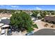 Well-manicured house featuring green lawns, mature trees, and a paved driveway on a sunny day at 645 S 54Th St, Mesa, AZ 85206