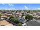 Expansive aerial view of a residential neighborhood featuring well-maintained homes and lush greenery under a bright blue sky at 645 S 54Th St, Mesa, AZ 85206