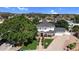 Aerial view of a grand two-story residence with lush landscaping, a circular driveway, and a well-maintained lawn at 645 S 54Th St, Mesa, AZ 85206