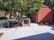 Backyard shed with a small dog run, surrounded by lush greenery and trees, providing storage and outdoor pet space at 645 S 54Th St, Mesa, AZ 85206