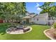 This backyard features green grass, a fire pit, and a covered patio, perfect for outdoor living and entertaining at 645 S 54Th St, Mesa, AZ 85206