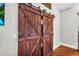 Interior shot of wooden sliding barn door in room with hardwood flooring at 645 S 54Th St, Mesa, AZ 85206