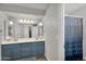 This stylish bathroom features double sinks, modern lighting, and a patterned shower curtain for added privacy at 645 S 54Th St, Mesa, AZ 85206