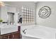 Bright bathroom featuring glass block window and separate soaking tub at 645 S 54Th St, Mesa, AZ 85206