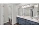 A well-lit bathroom featuring dual sinks, sleek cabinetry, and a separate toilet room for added convenience at 645 S 54Th St, Mesa, AZ 85206