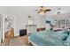 Spacious bedroom featuring exercise equipment, dresser, ceiling fan, and a cozy bed with blue covers at 645 S 54Th St, Mesa, AZ 85206