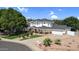 Stately two-story home featuring a covered front porch, beautiful landscaping, and a wide driveway for ample parking at 645 S 54Th St, Mesa, AZ 85206