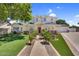 Inviting home with a red door, lush lawn, and beautiful landscaping in a desirable neighborhood at 645 S 54Th St, Mesa, AZ 85206