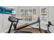 At-home gym featuring an exercise bike, a Total Gym, a treadmill, and large shuttered windows at 645 S 54Th St, Mesa, AZ 85206